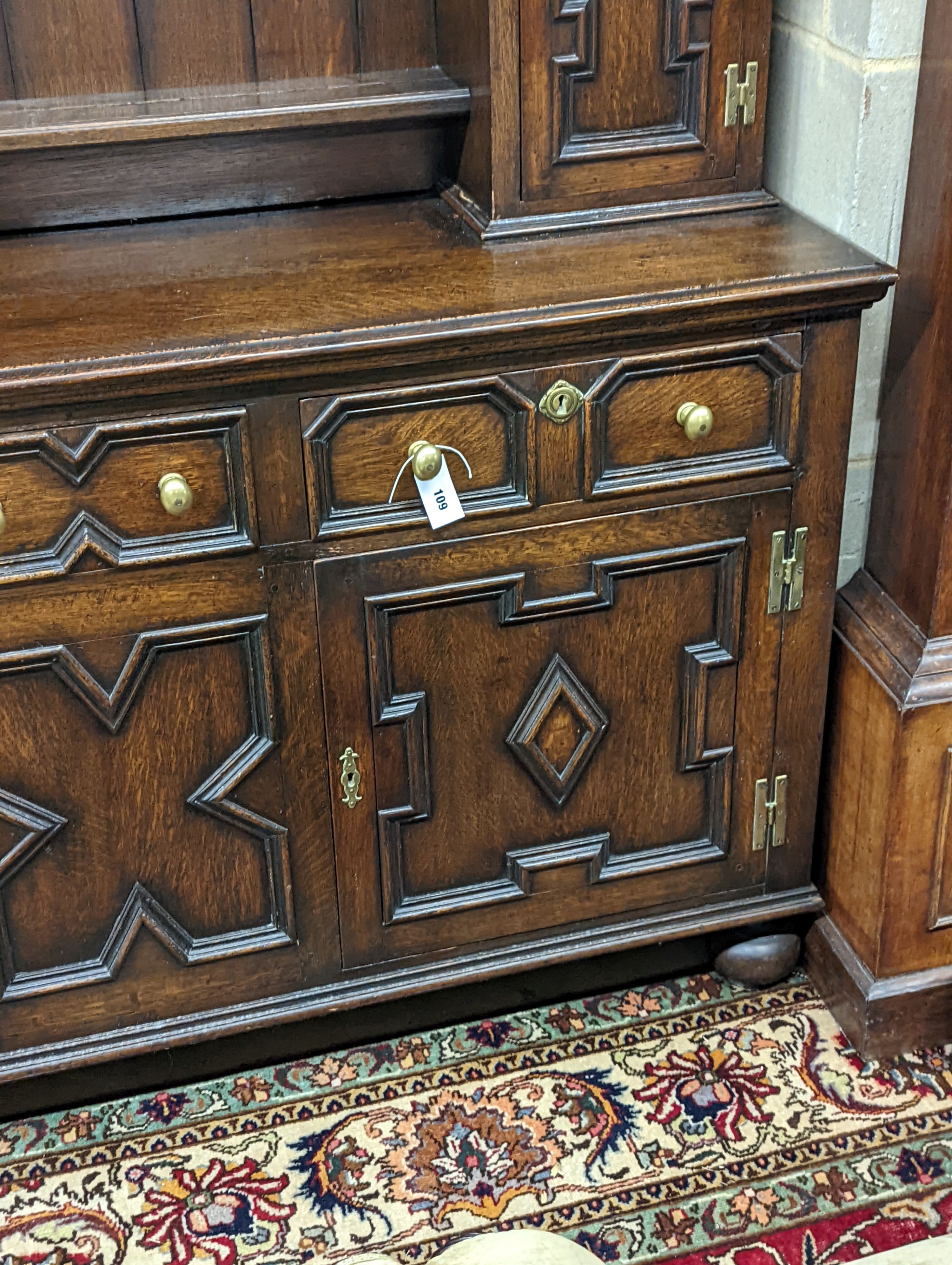 An early 20th century Jacobean revival oak dresser, width 168cm, depth 48cm, height 218cm